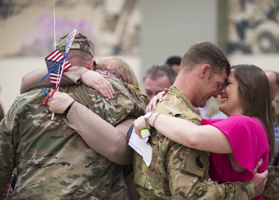 soldiers reuniting with their families upon completion of their tour of duty